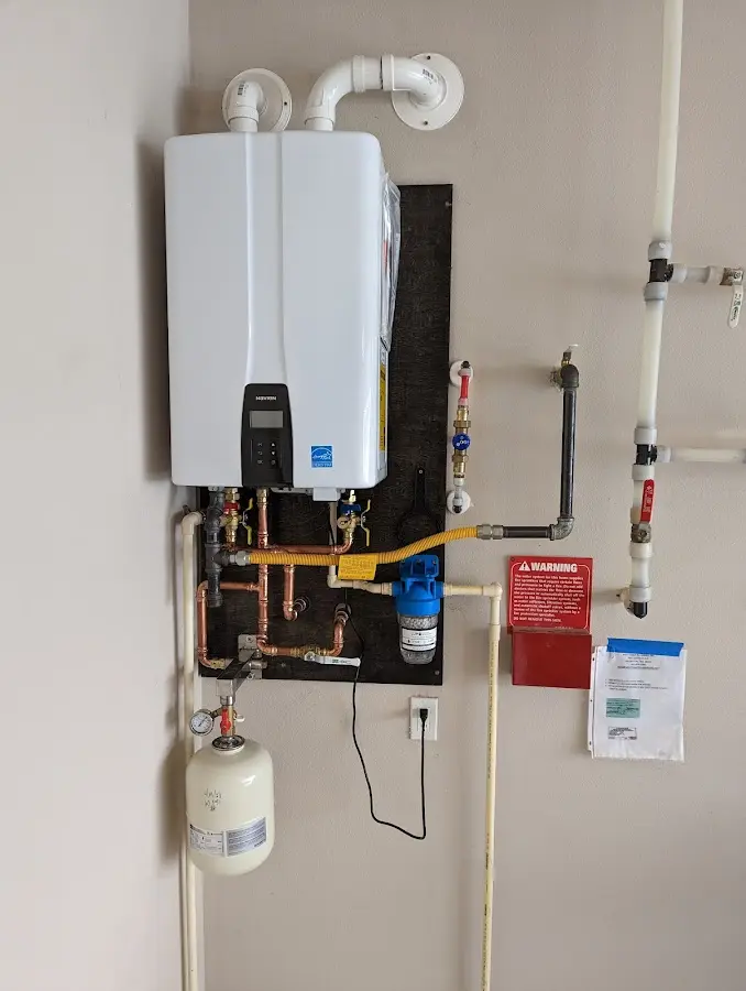 Professional plumber installing copper piping in a Alhambra home